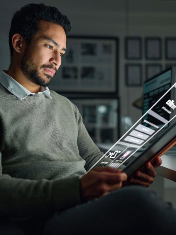 man sitting in chair on ipad